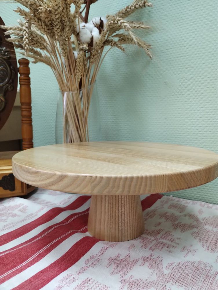 The cake stand is wooden